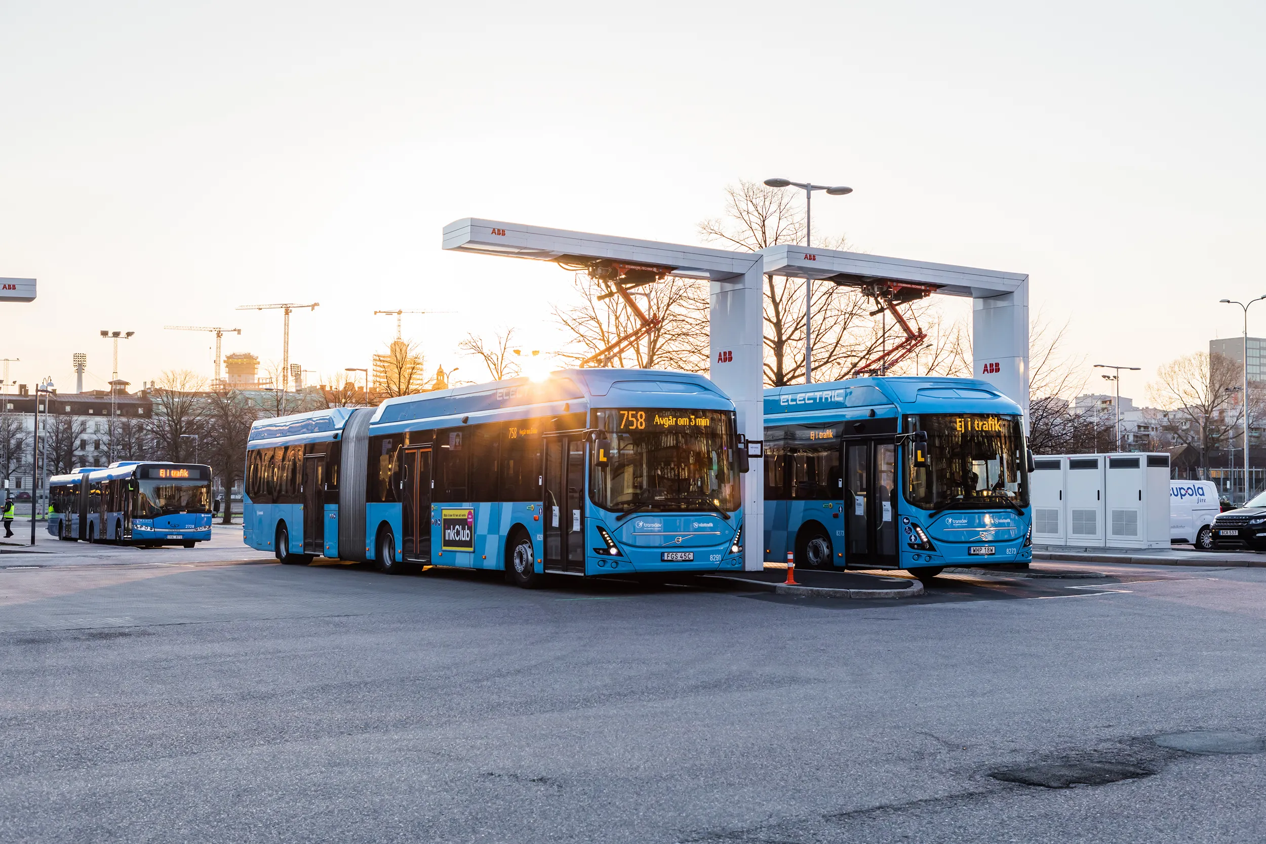 Two electric Västtrafik buses charging at a bus station in Heden, Gothenburg.