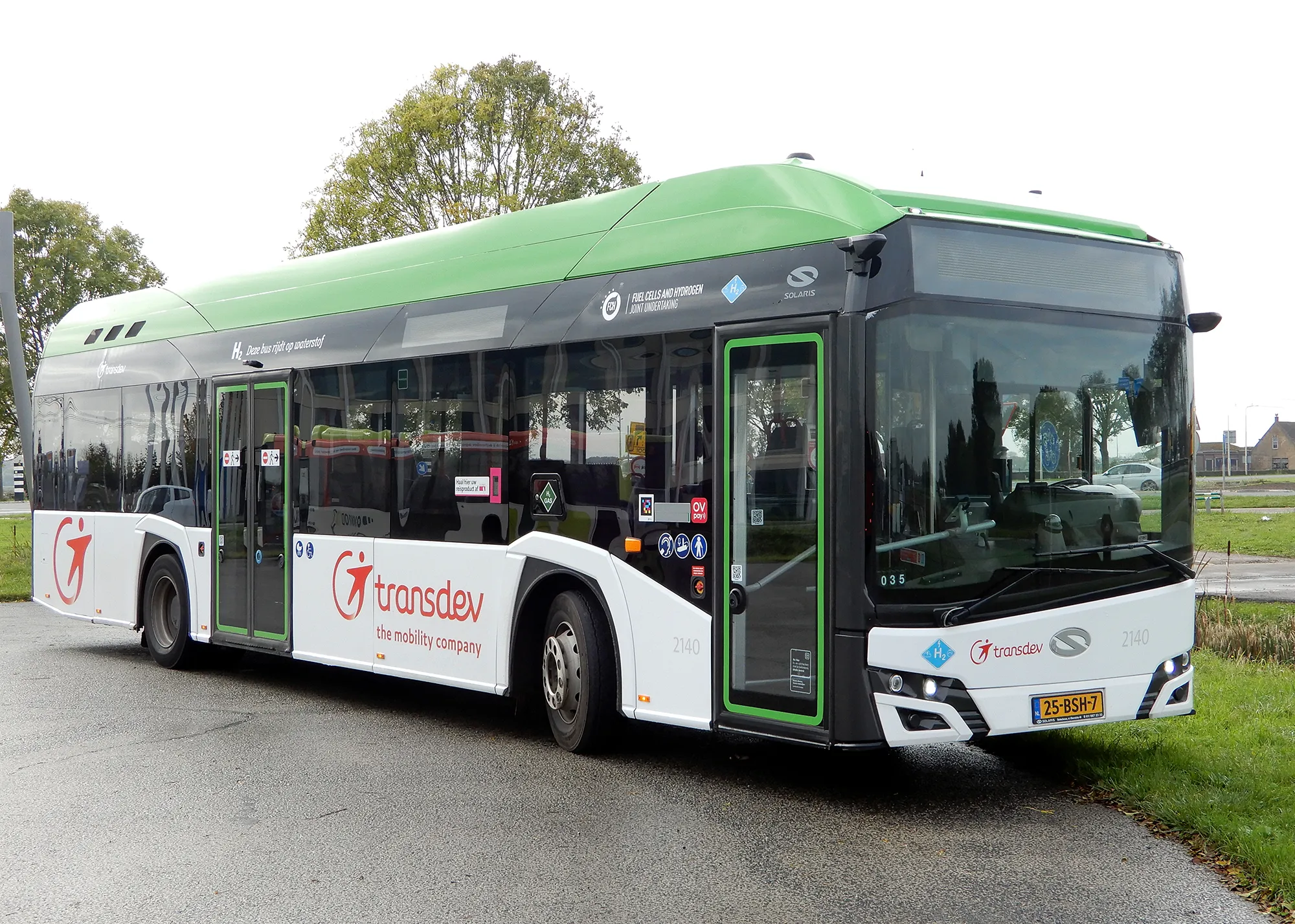 A green and white bus from Transdev in the Netherlands.